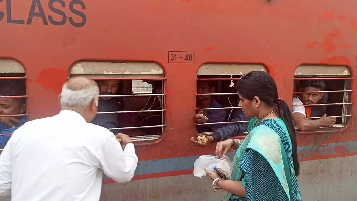 छठ पूजा पर्व पर ट्रेन यात्रियों को बांटा भोजन
